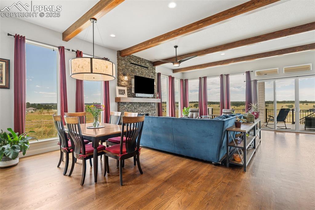 Dining area featuring wood finished floors, beam ceiling, and recessed lighting
