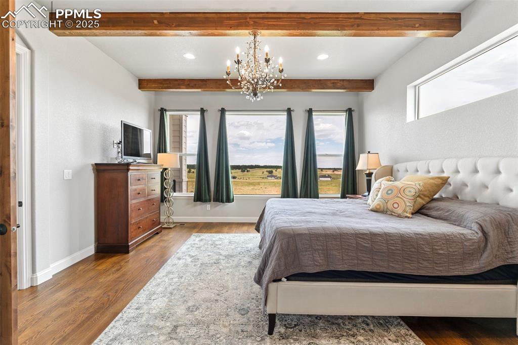Bedroom featuring wood finished floors, beam ceiling, a chandelier, and recessed lighting
