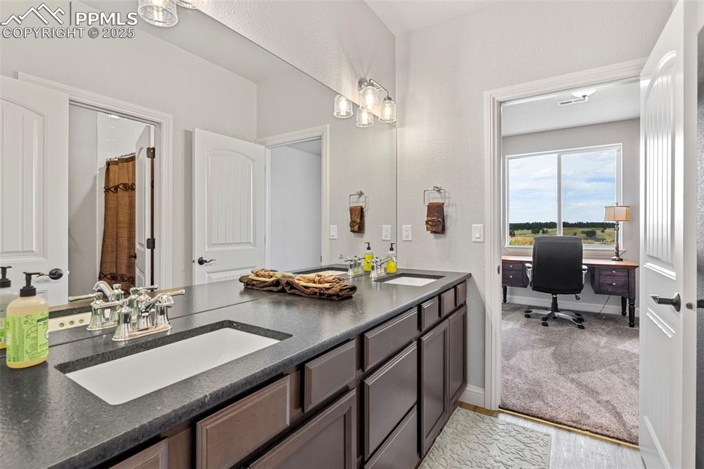 Full bathroom featuring a sink and light wood-type flooring