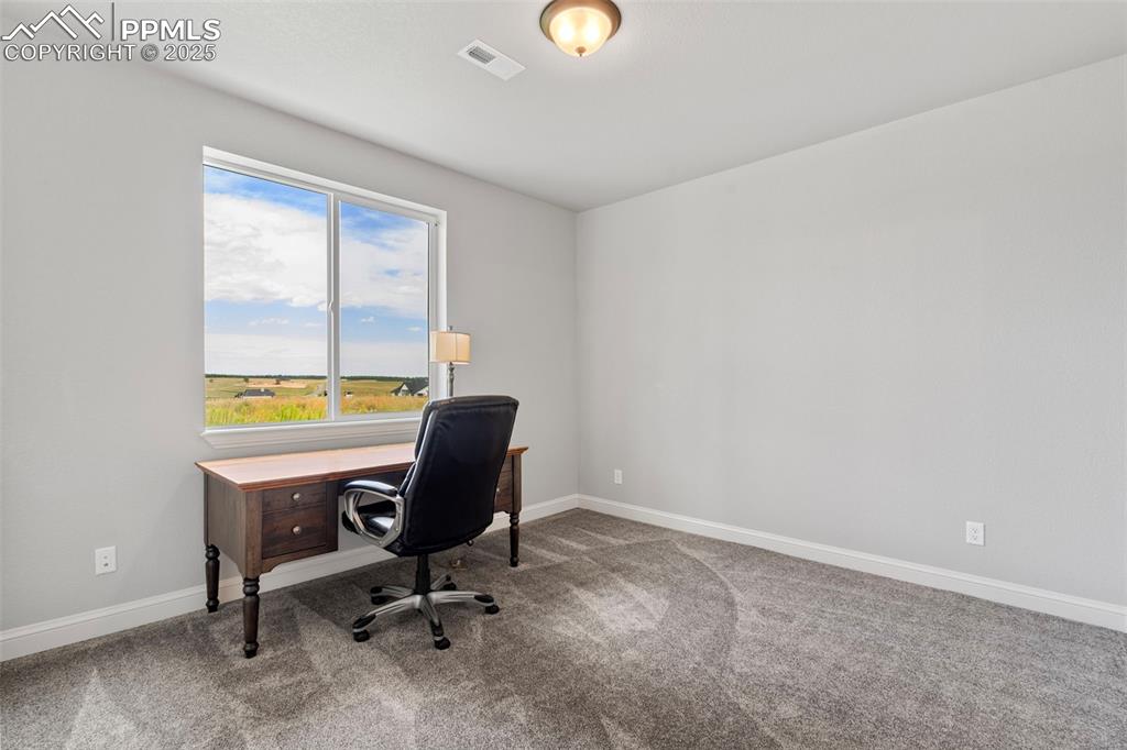 Carpeted office featuring baseboards