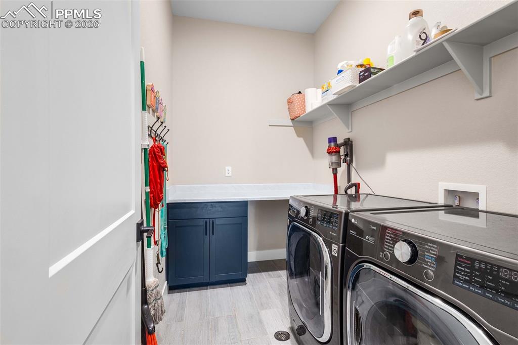main level laundry room with built in shelving 