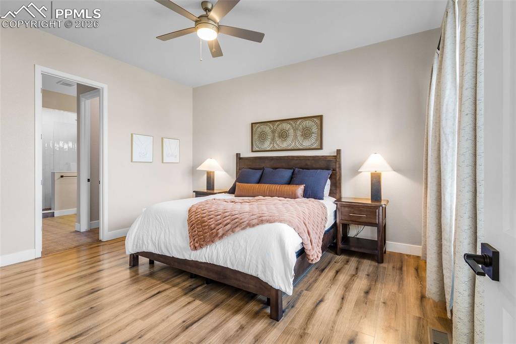 main level primary bedroom with walk in closet and ensuite bathroom