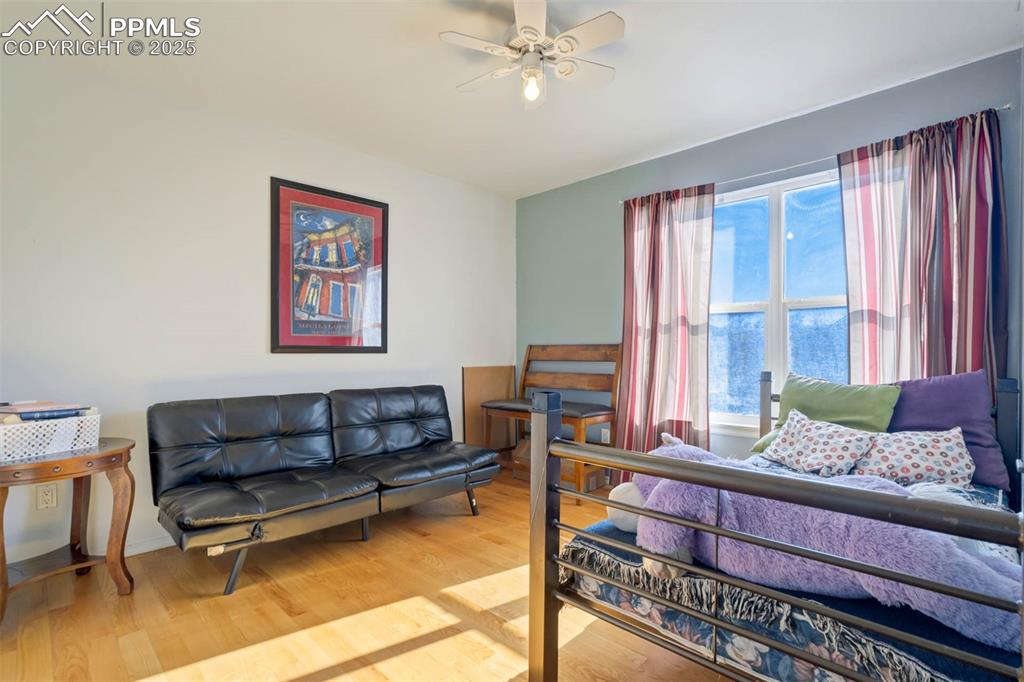Bedroom featuring wood finished floors and a ceiling fan