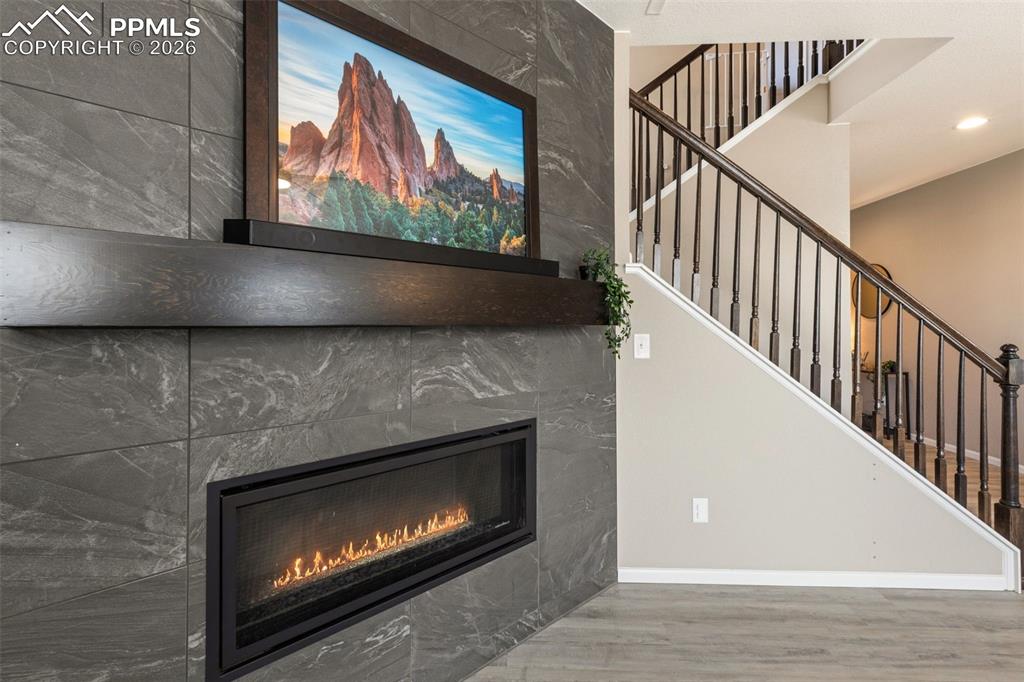 Floor-to-ceiling tile fireplace with oversized cosmopolitan fireplace