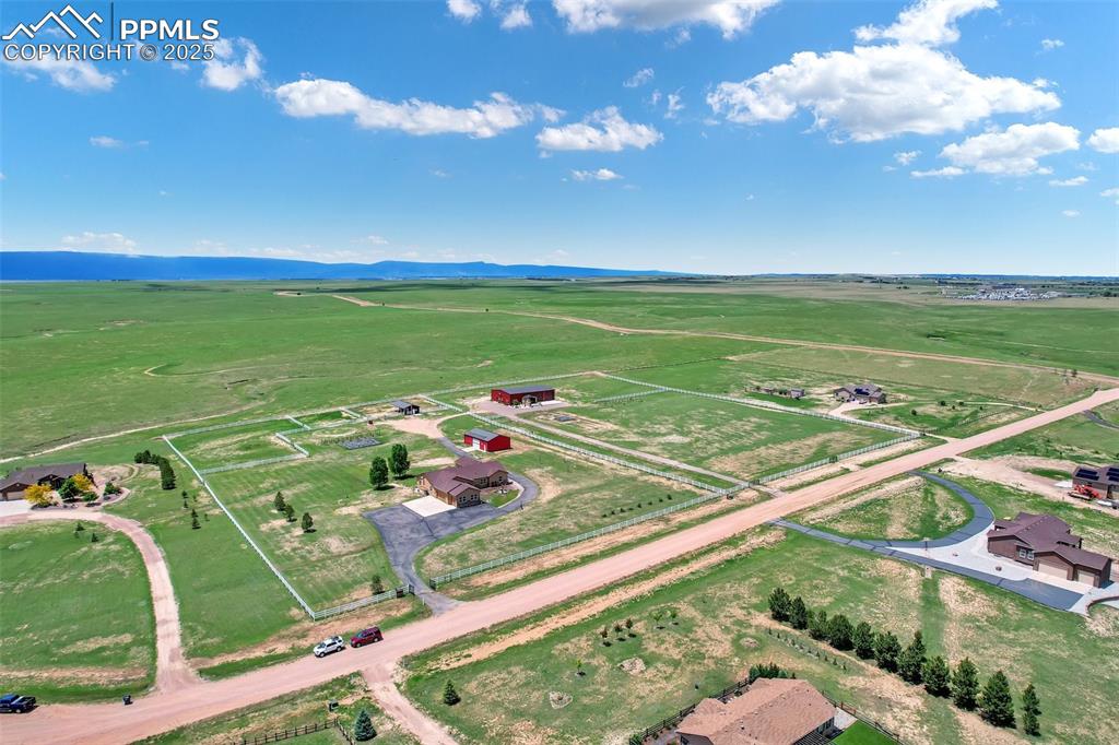 Aerial view with a rural view entire property is fenced.