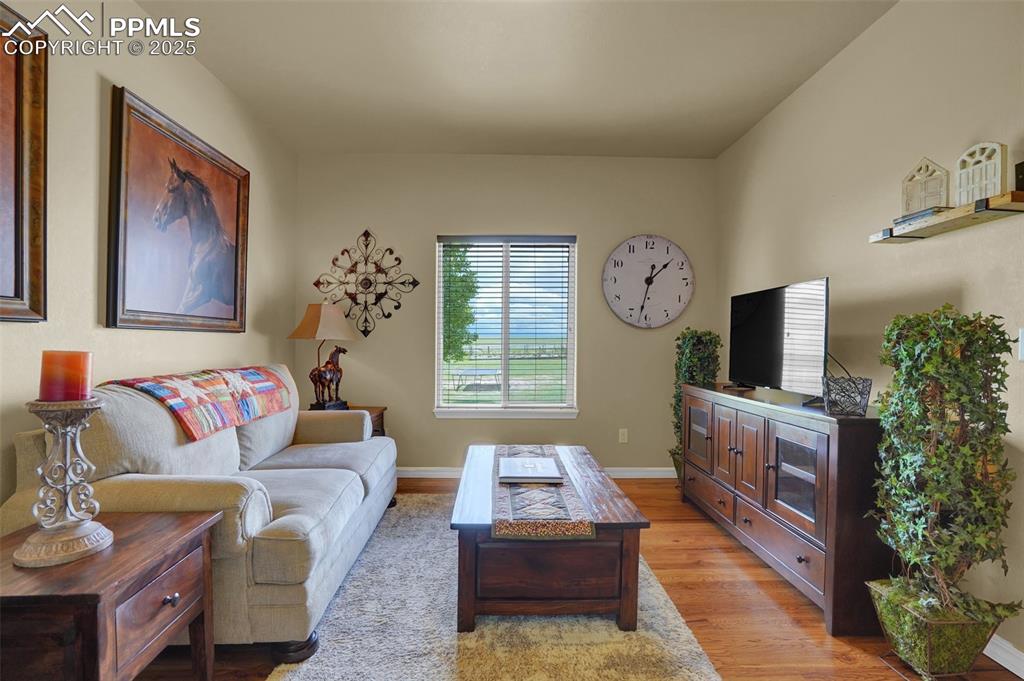 Living area with light wood-style flooring and baseboards