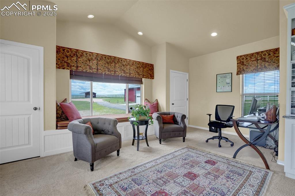 Office area featuring recessed lighting, carpet, vaulted ceiling, and wainscoting