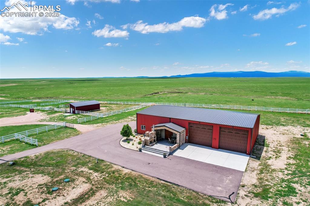 Drone / aerial view of banrdominium with a rural view and a mountain view