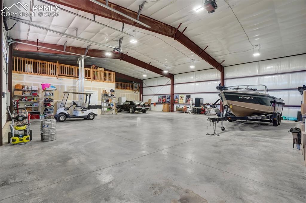 Garage featuring a garage door opener, attached to barndominium