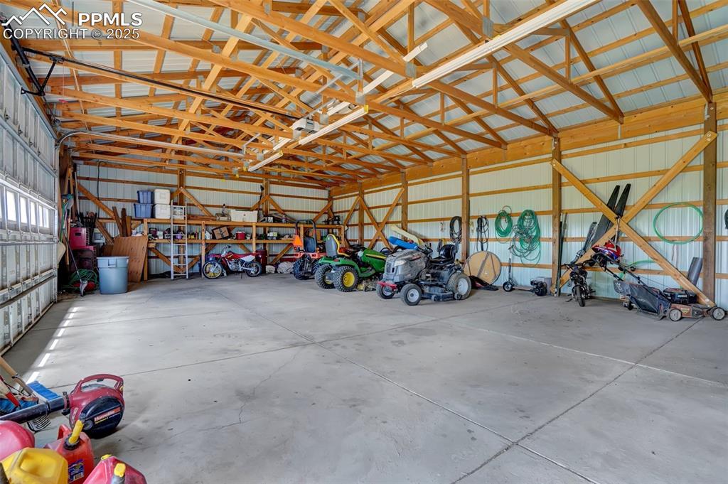 Garage featuring metal wall attaches to barn 