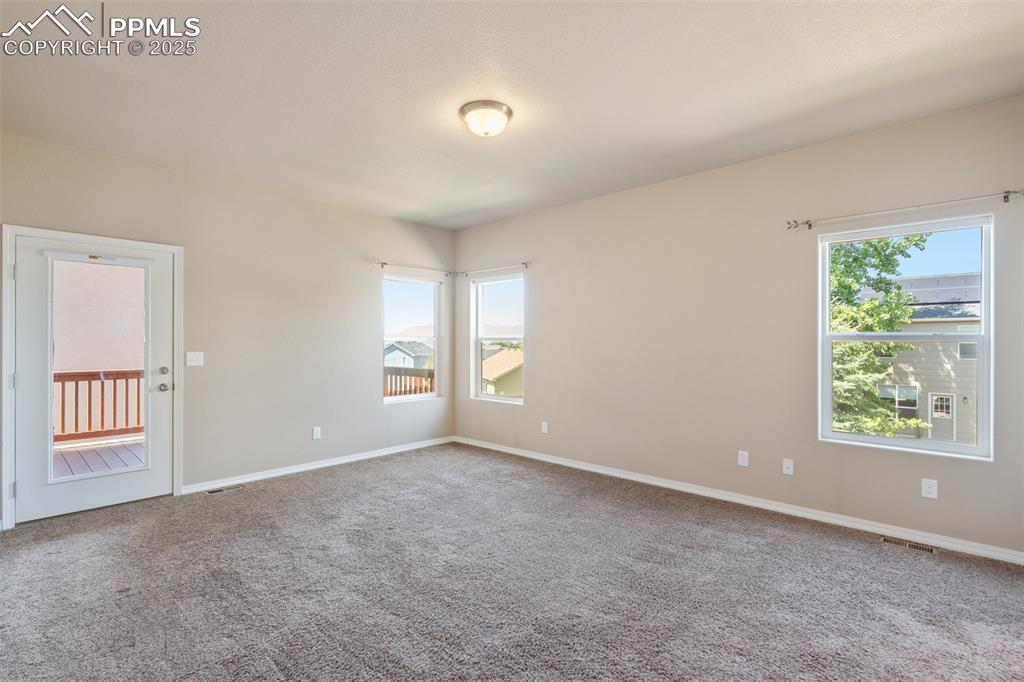 Primary bedroom main level - Empty room with carpet flooring and baseboards