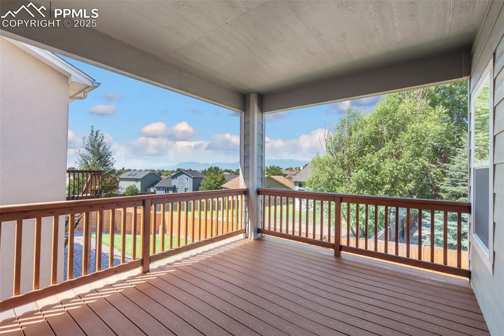 Main level deck with walk-out from Dining Room and Primary Bedroom - Wooden deck with a residential view