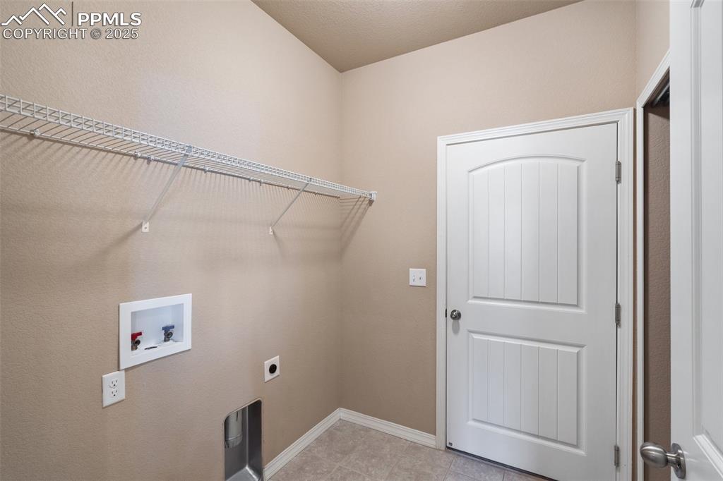 Laundry area featuring hookup for a washing machine and hookup for an electric dryer