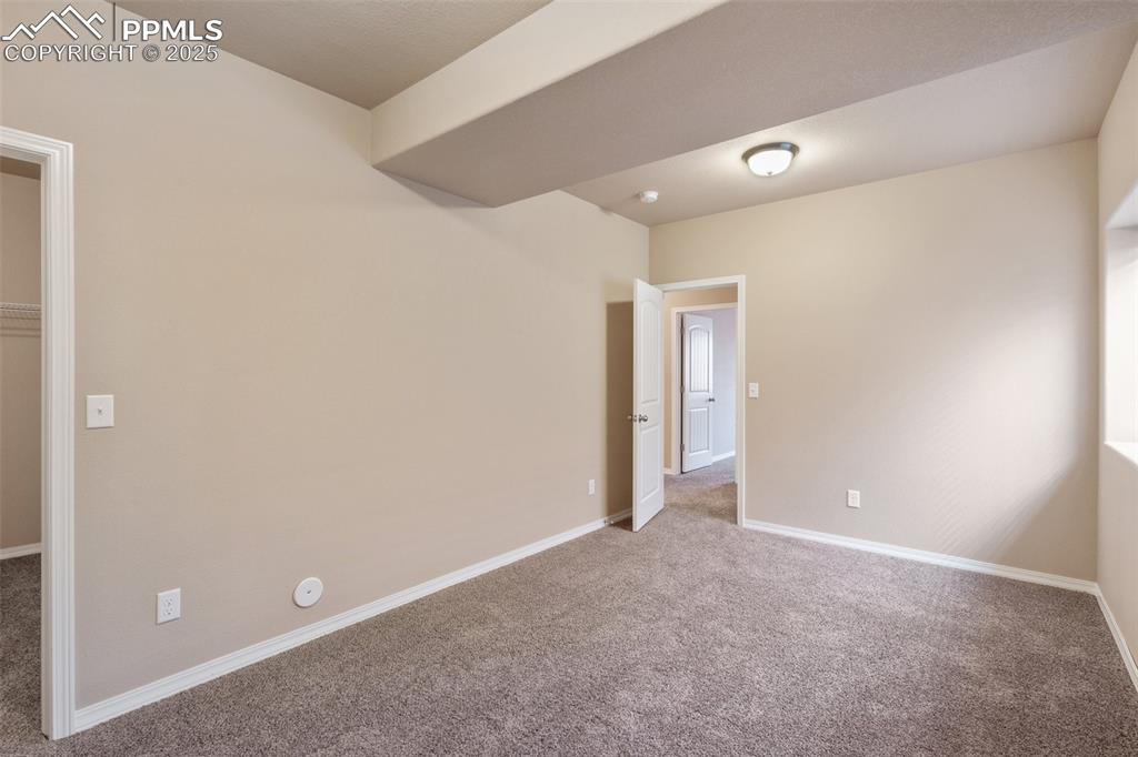 Basement Bedroom - Carpeted spare room featuring baseboards