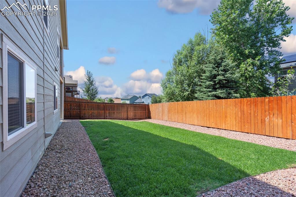 View of fenced backyard