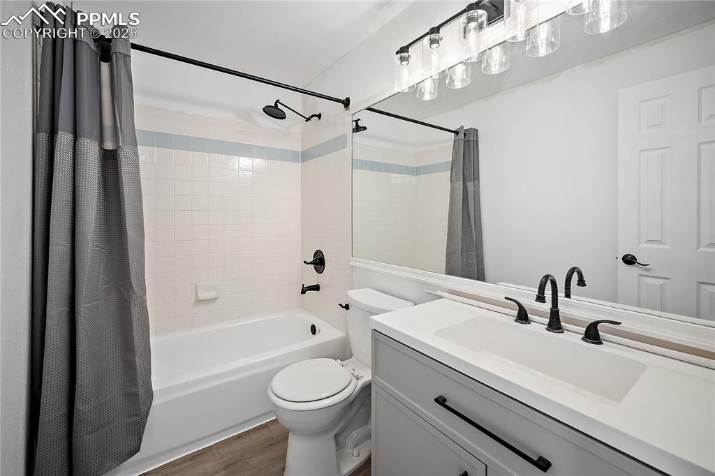 Upstairs full bath with new vanity, lighting and flooring.