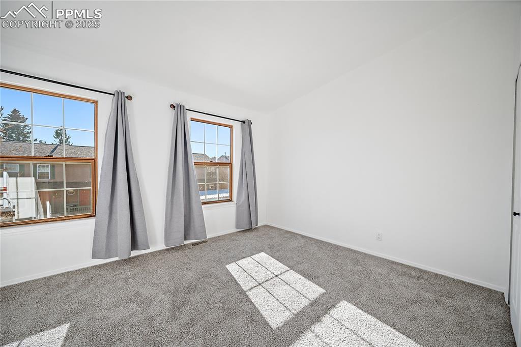 Upstairs bedroom 2 with vaulted ceilings. 