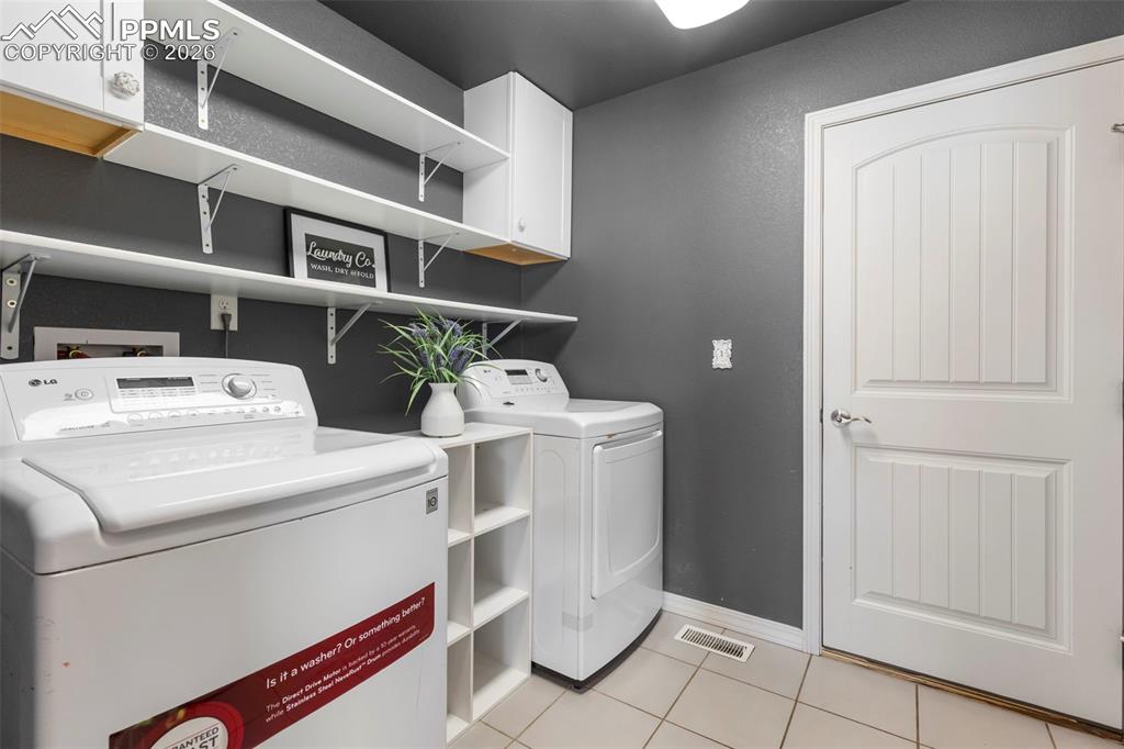 Primary bathroom featuring a soaking tub, walk-in shower with glass enclosure, and tile flooring.