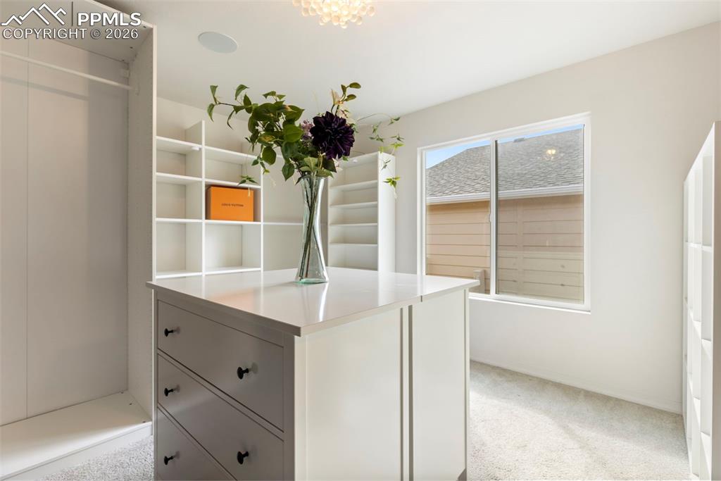 Main floor full bathroom adjacent to bedroom  with tub/shower combination, vanity, and tile flooring