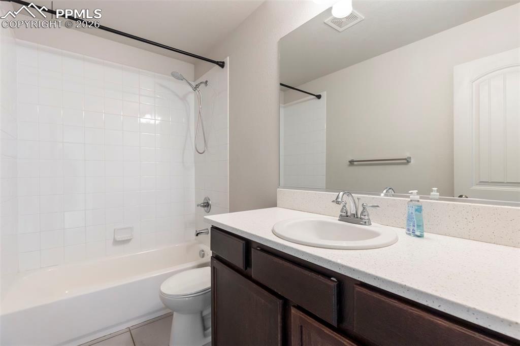 Spacious finished lower level recreation room with recessed lighting and flexible open layout.