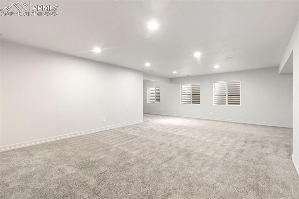 Basement full bathroom with tub/shower combination, single-sink vanity, and tile flooring.