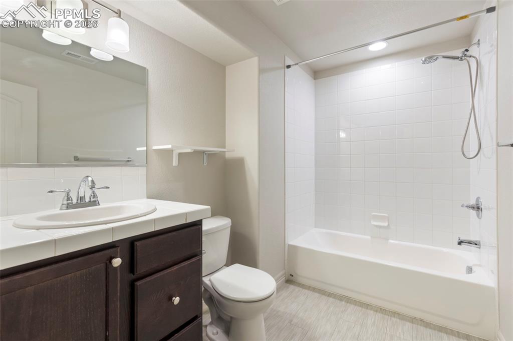 Finished basement bedroom with carpeted flooring, recessed lighting, and egress window
