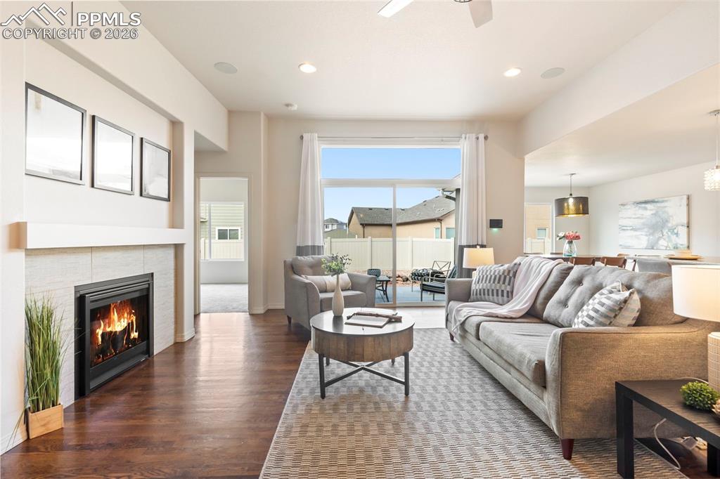 Living room featuring a ceiling fan, beautiful hardwood floors, and recessed lighting
