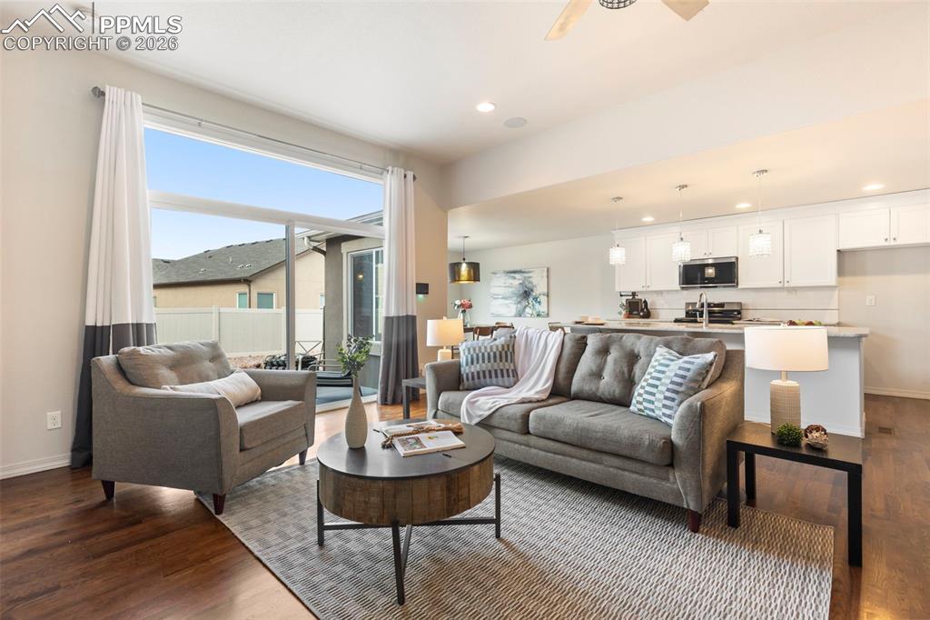 Open-concept main-level living with hardwood floors and seamless flow to the kitchen and dining areas.