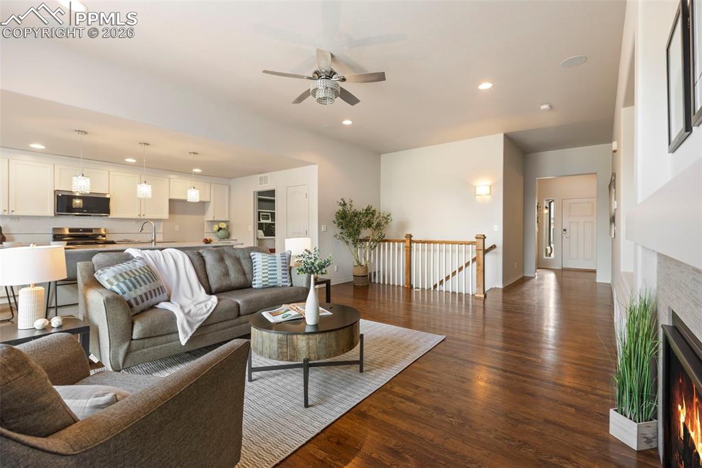 Great room featuring a gas fireplace, surround sound, media center, and indoor/outdoor access for Colorado living