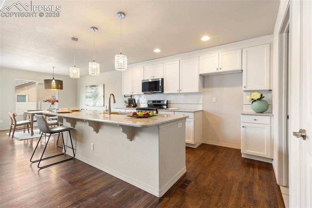 Spacious kitchen with center island, pantry storage, and open sightlines to the living area.