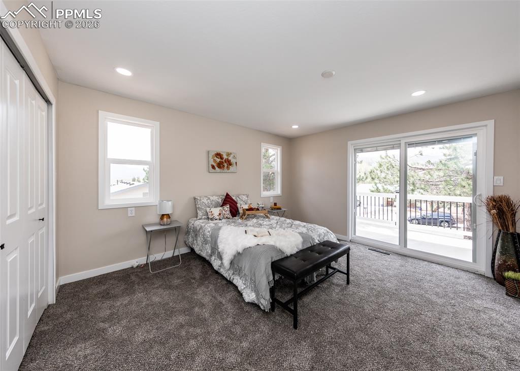 Bedroom with carpet floors, access to exterior, a closet, recessed lighting, and multiple windows