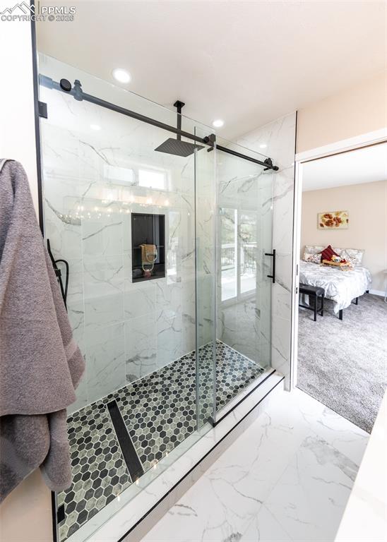 Full bathroom with marble finish floors, a marble finish shower, ensuite bathroom, and recessed lighting