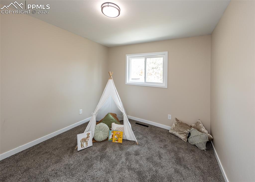 Playroom with carpet floors and baseboards