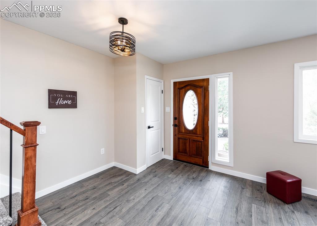 Entryway featuring wood finished floors and stairs