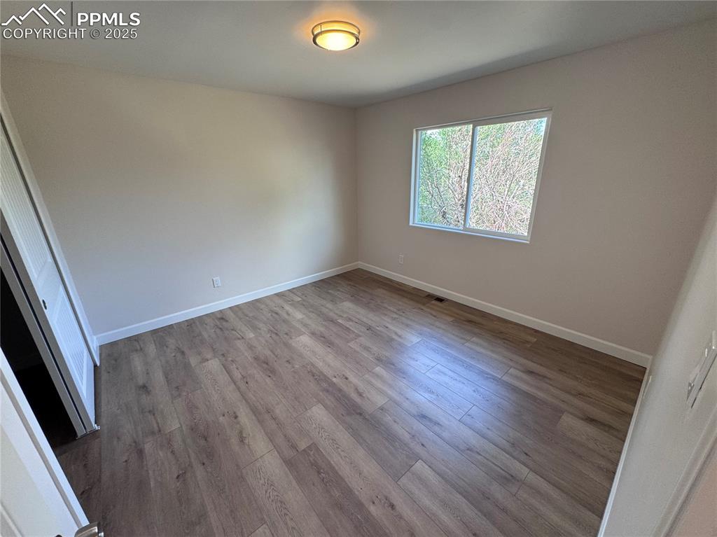 Unfurnished bedroom featuring a closet and light wood finished floors