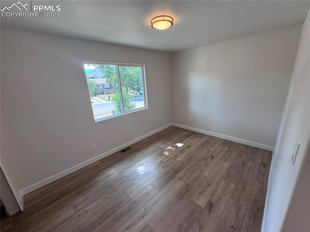 Unfurnished room featuring baseboards and light wood-style flooring