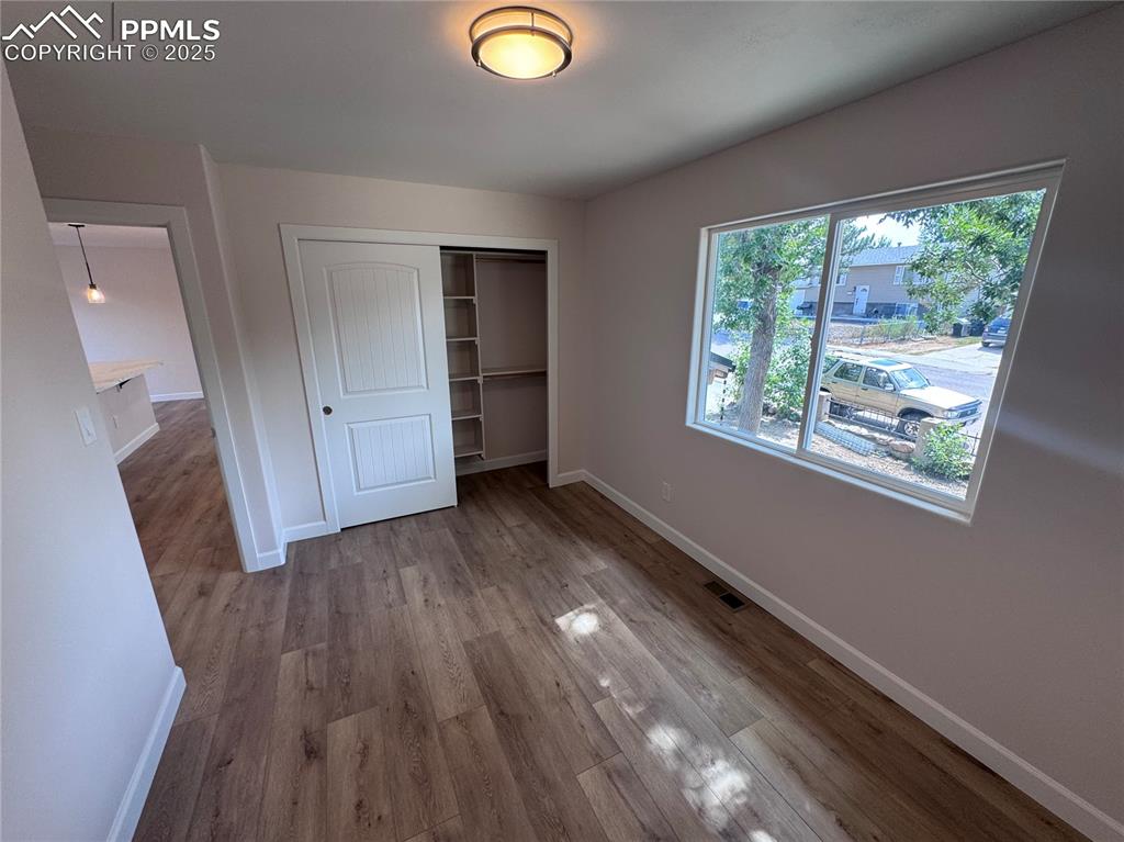 Unfurnished bedroom featuring a closet and light wood-type flooring