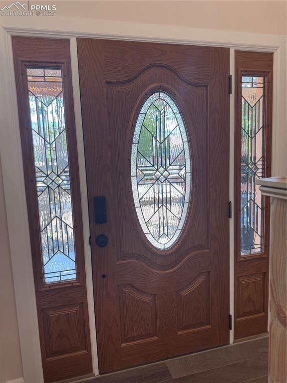 Foyer entrance with plenty of natural light and wood finished floors