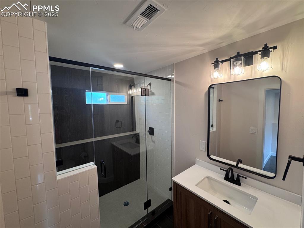 Bathroom with vanity and a shower stall