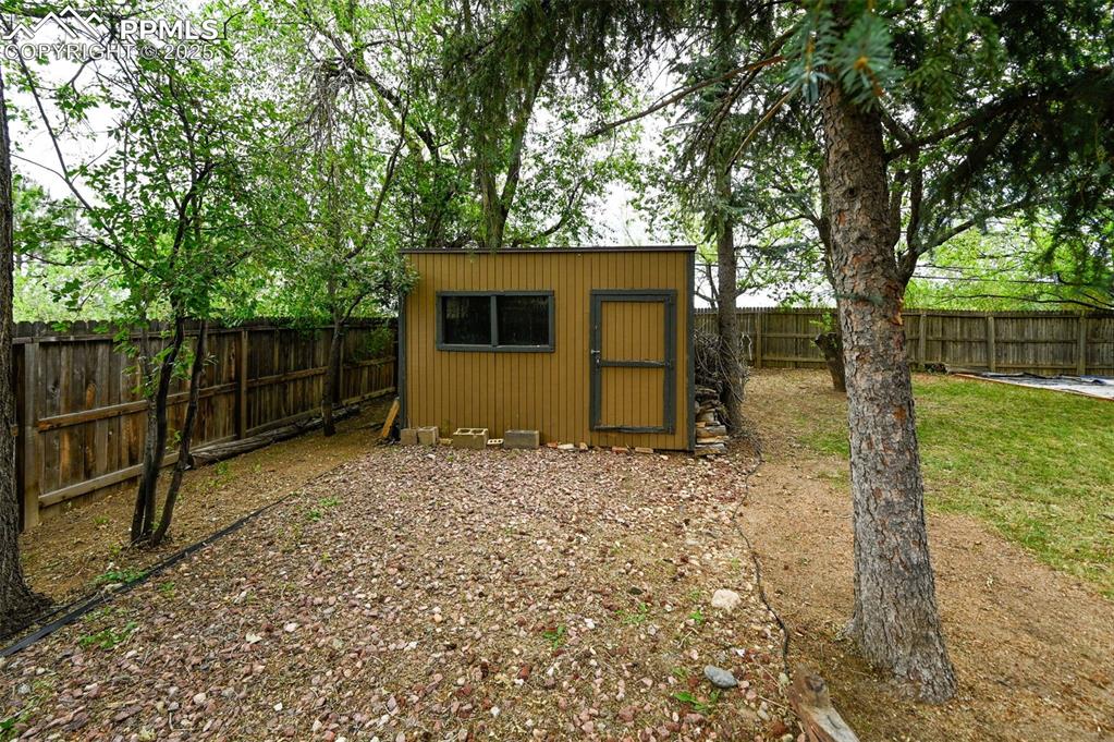 shed with a fenced backyard