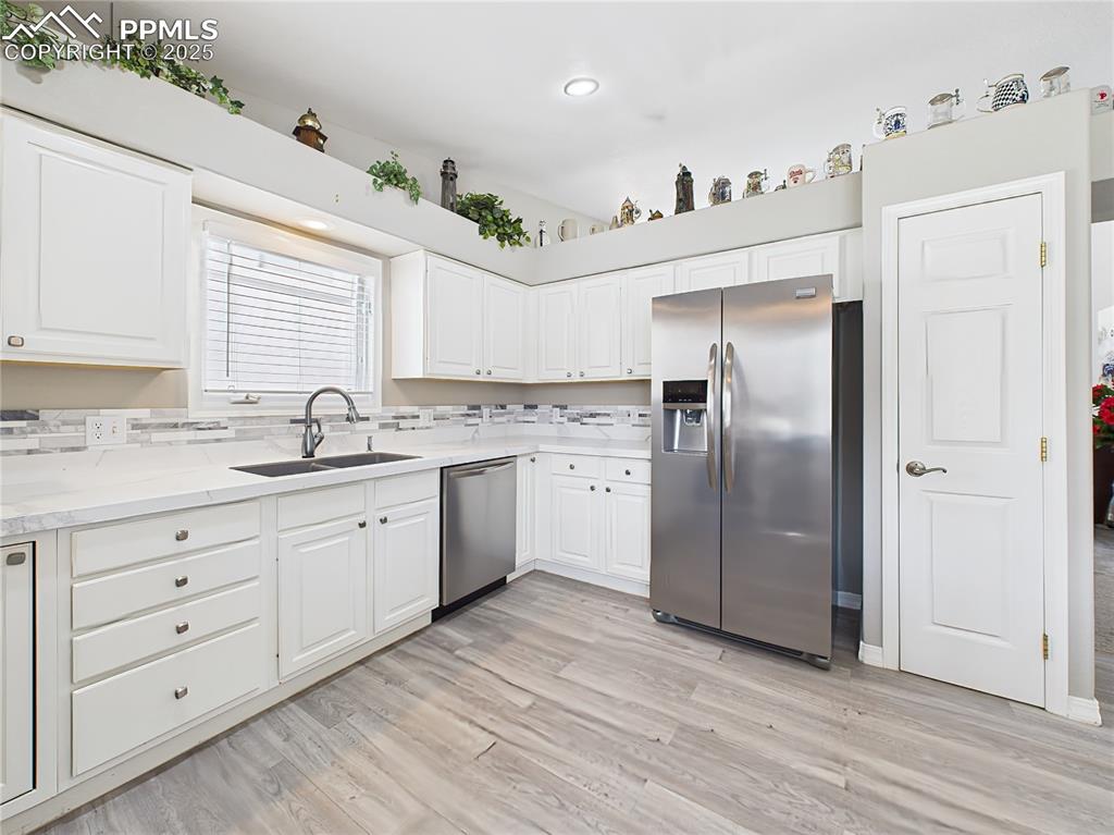 Refrigerator Wall View – Fridge wall with additional cabinetry and pantry, showcasing functional storage and sleek finishes.