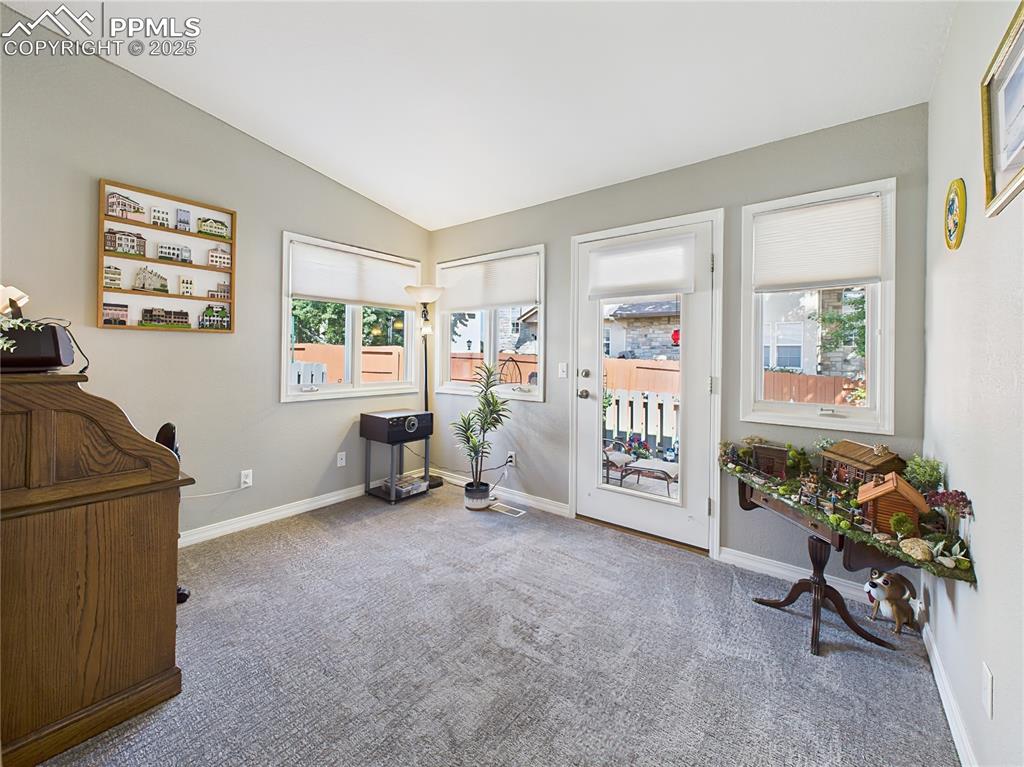 Office / Sunroom – Flexible office or hobby space filled with windows and a glass door leading to the private rear patio.