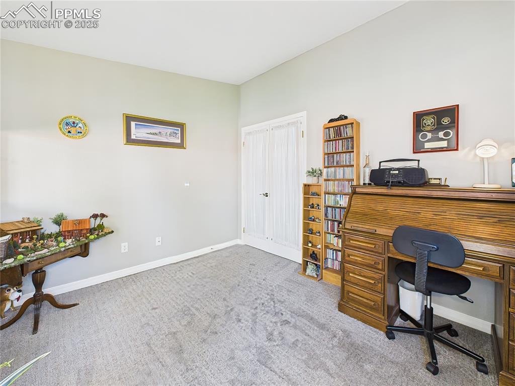 Home Office – Features French doors, a large window for natural light, and ample wall space for storage or shelving.