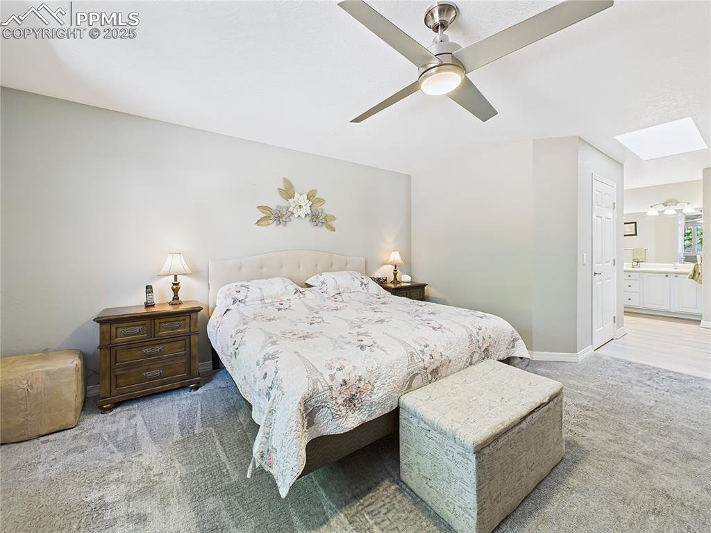 Primary Bedroom – Another view of the serene primary suite showcasing the elegant ceiling fan and neutral color palette.