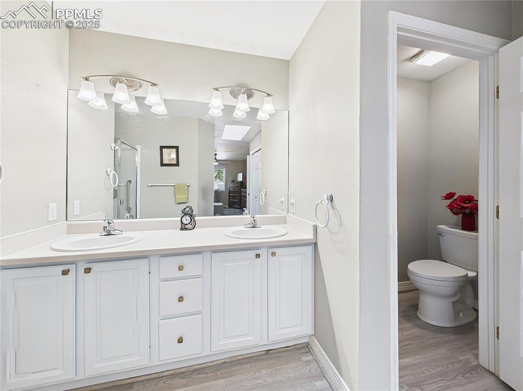 Water Closet – Separate enclosed toilet area provides privacy within the primary bath suite.