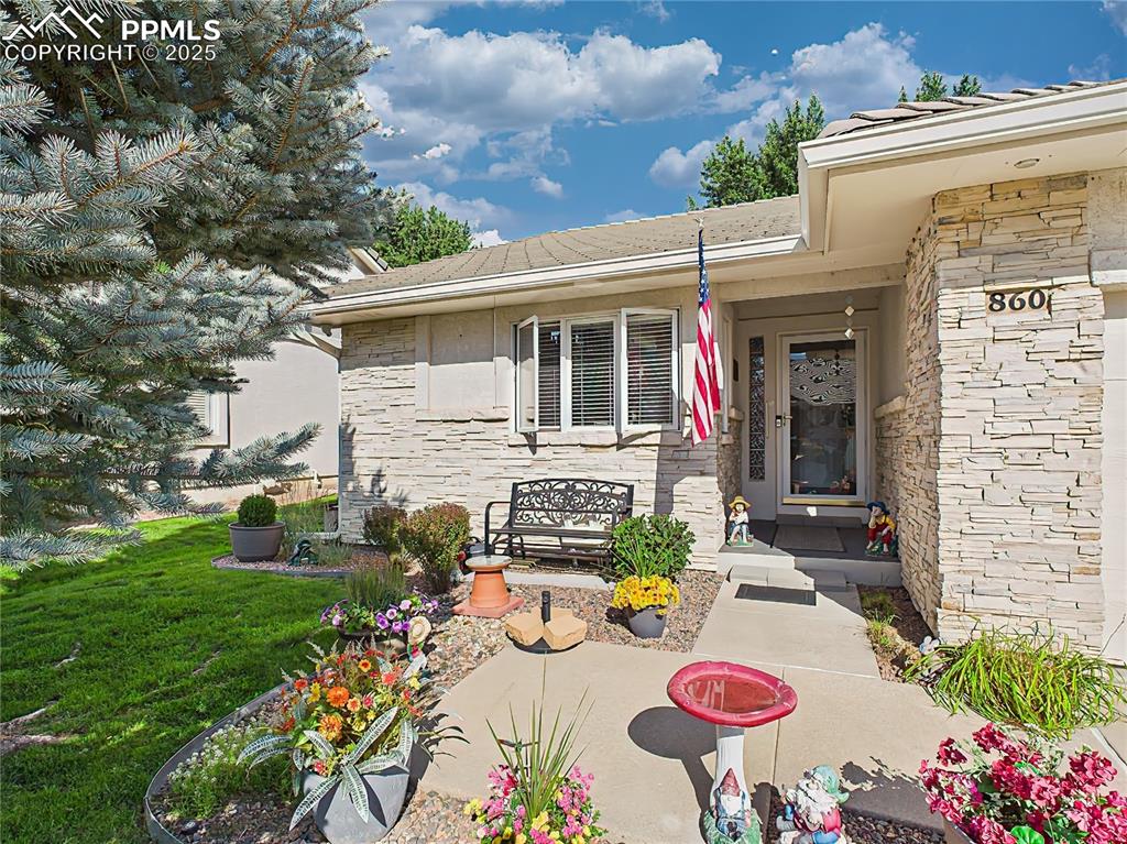 Front Porch – Thoughtfully landscaped entryway with colorful planters, flagstone accents, and charming touches throughout.