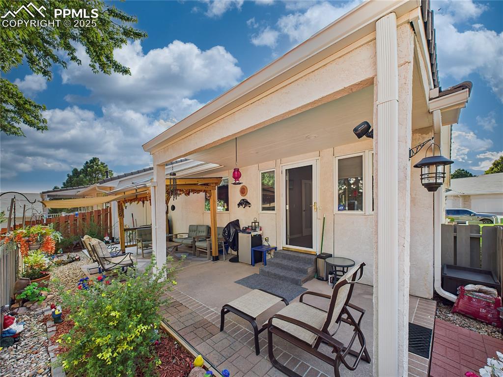Covered Patio – Thoughtfully designed covered space includes garden beds, and access to interior living areas.