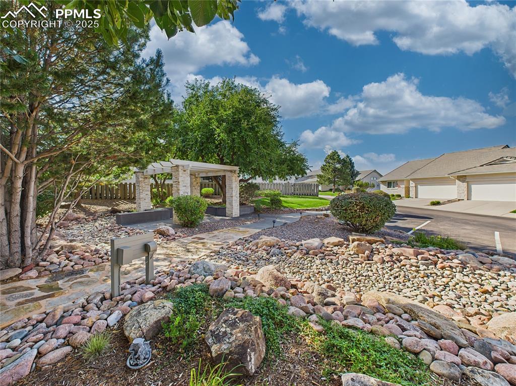 Community Pavilion – Covered neighborhood kiosk with landscaped surroundings and decorative stone columns off Guest Parking.