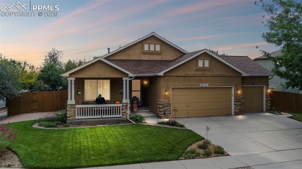 Craftsman inspired home featuring a porch, stone siding, and concrete driveway