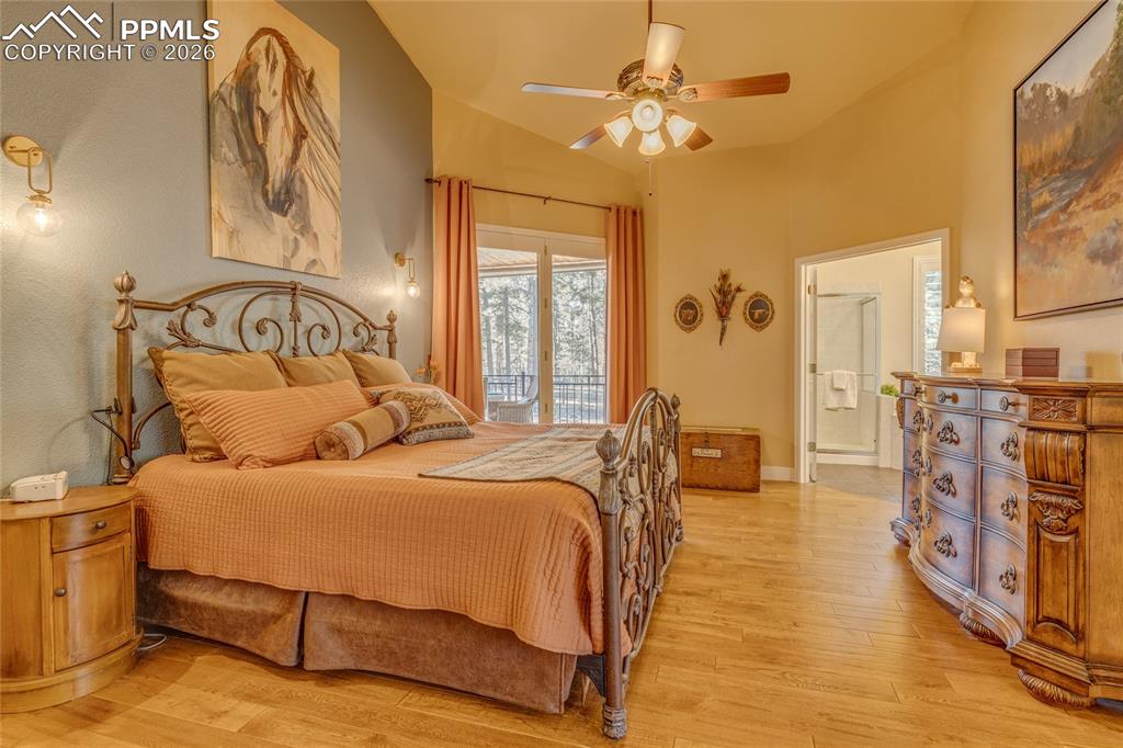 Primary bedroom with sliding door accessing back covered deck.